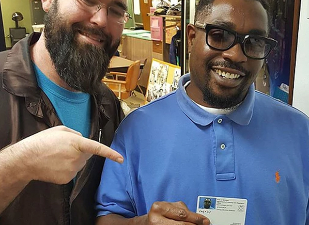 A barber showing off his license